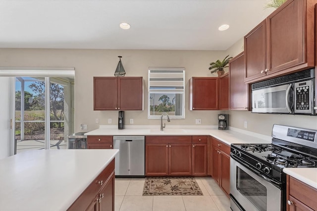 kitchen with light countertops, recessed lighting, appliances with stainless steel finishes, light tile patterned flooring, and a sink