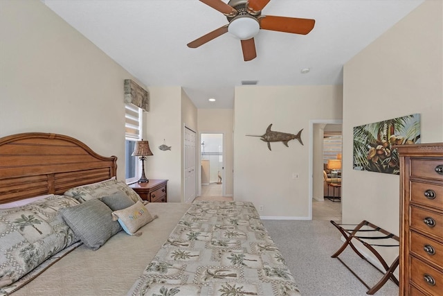 bedroom with a ceiling fan, baseboards, visible vents, and connected bathroom