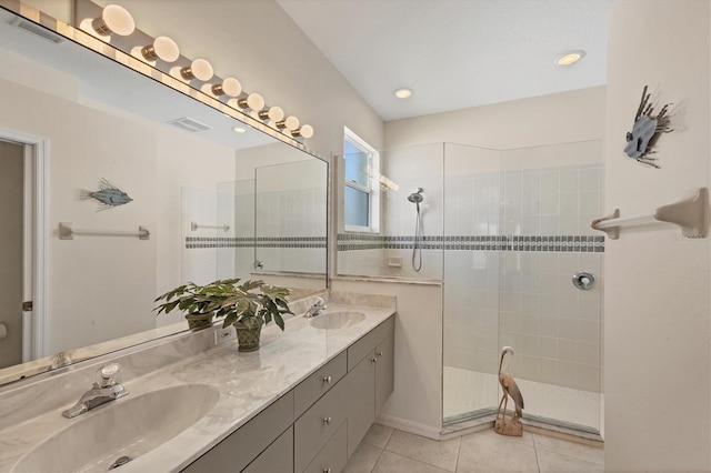 full bath with tile patterned floors, a walk in shower, double vanity, and a sink