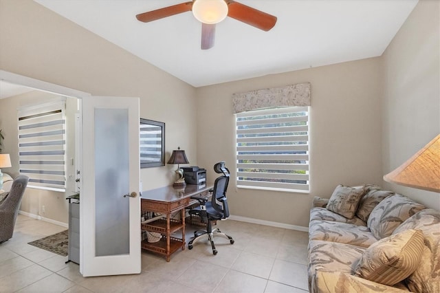 office space featuring light tile patterned flooring, baseboards, lofted ceiling, and a ceiling fan