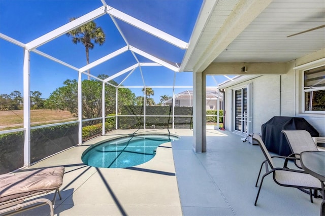 pool featuring a patio area, grilling area, and glass enclosure