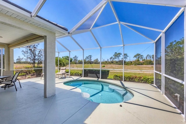 outdoor pool with a patio area and glass enclosure