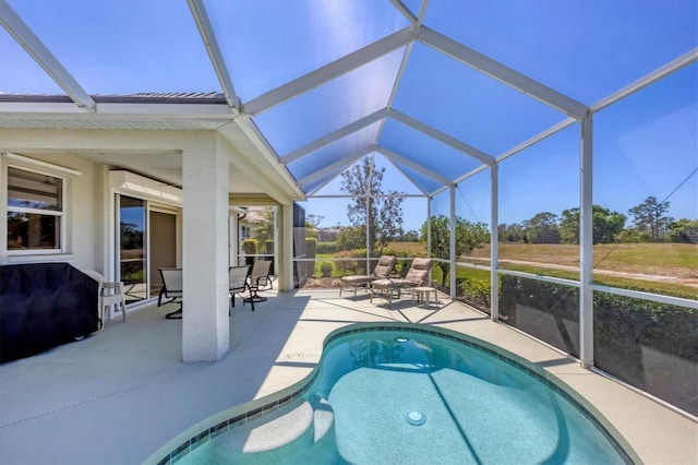 outdoor pool featuring area for grilling, a lanai, and a patio area