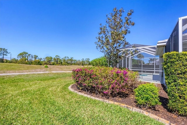 view of yard featuring glass enclosure