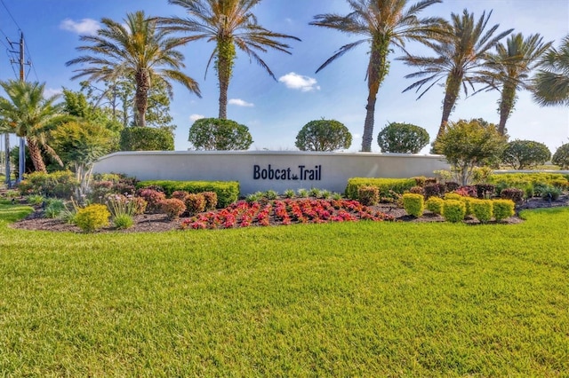 community / neighborhood sign with a yard