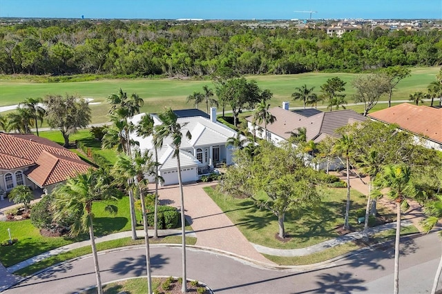 birds eye view of property with golf course view and a forest view