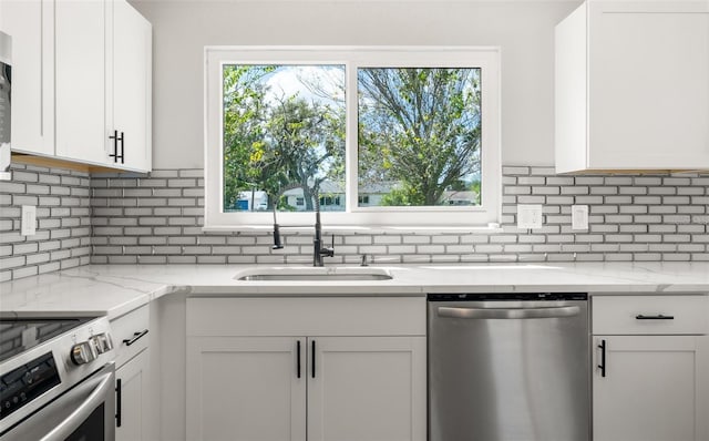 kitchen with a sink, stainless steel appliances, and white cabinets