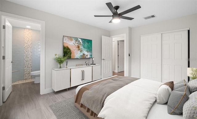 bedroom with visible vents, a ceiling fan, a closet, connected bathroom, and baseboards