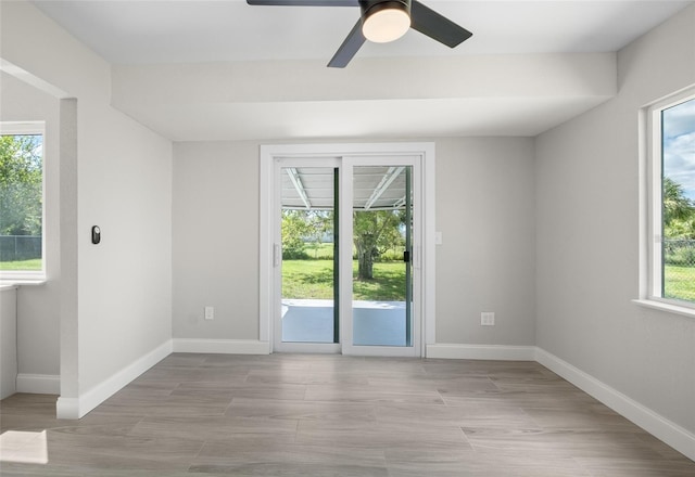 spare room featuring light wood-style floors and baseboards