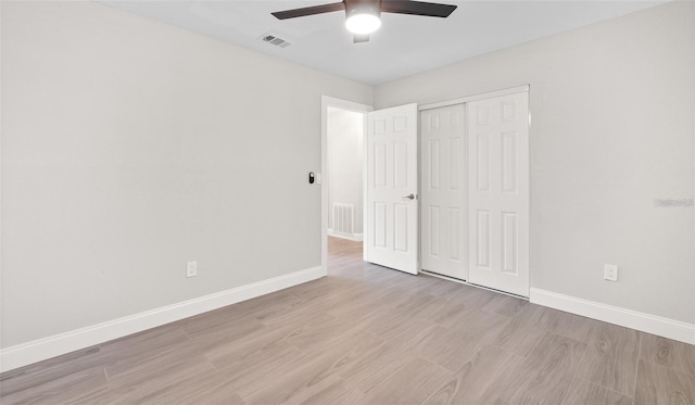 unfurnished bedroom featuring visible vents, baseboards, and light wood finished floors