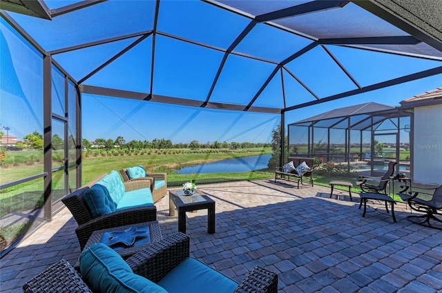 view of patio / terrace featuring a lanai, outdoor lounge area, and a water view