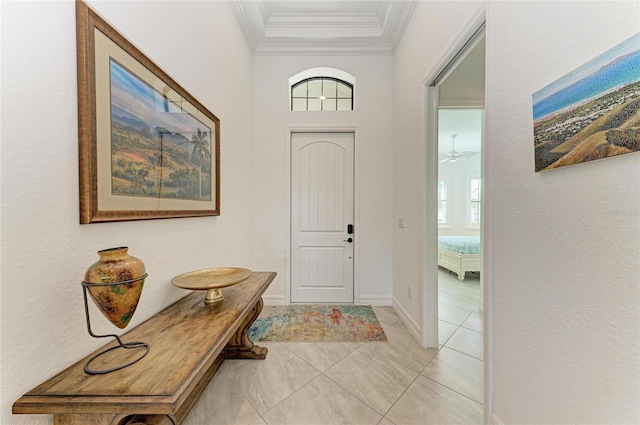 entrance foyer featuring crown molding and baseboards