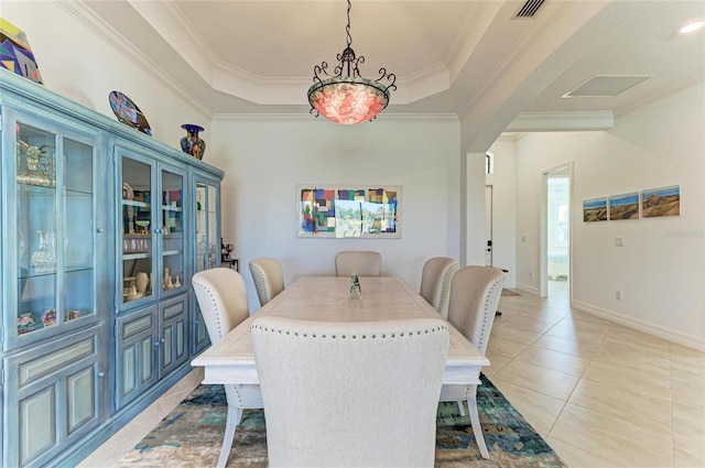 dining area featuring visible vents, a tray ceiling, arched walkways, crown molding, and light tile patterned floors