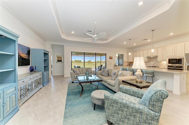 living room featuring light tile patterned floors, a raised ceiling, recessed lighting, and crown molding