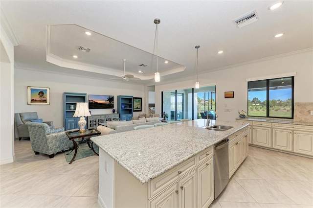 kitchen with visible vents, dishwasher, ornamental molding, cream cabinets, and a raised ceiling