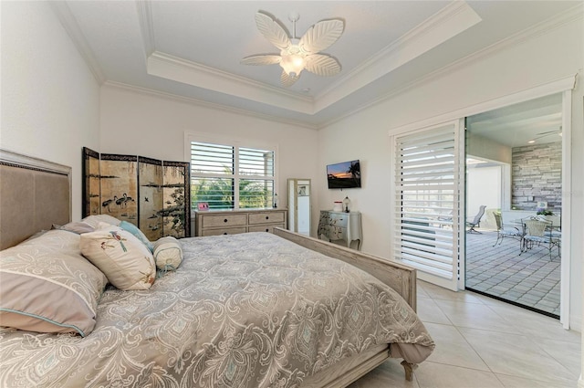 bedroom with a tray ceiling, light tile patterned flooring, access to exterior, and ornamental molding