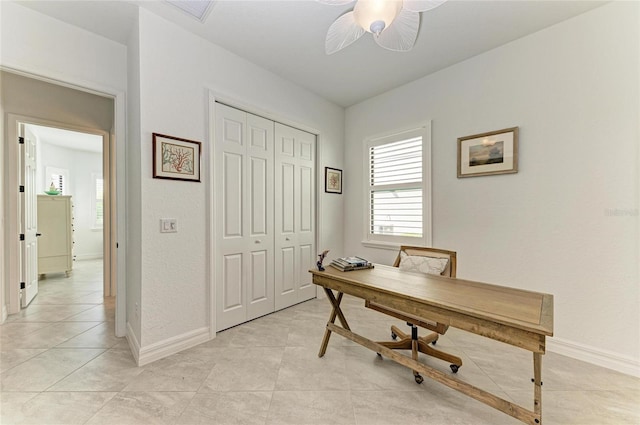 office space featuring light tile patterned flooring, visible vents, baseboards, and a ceiling fan