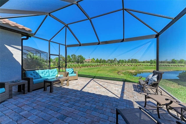 view of patio featuring an outdoor living space, a water view, and a lanai