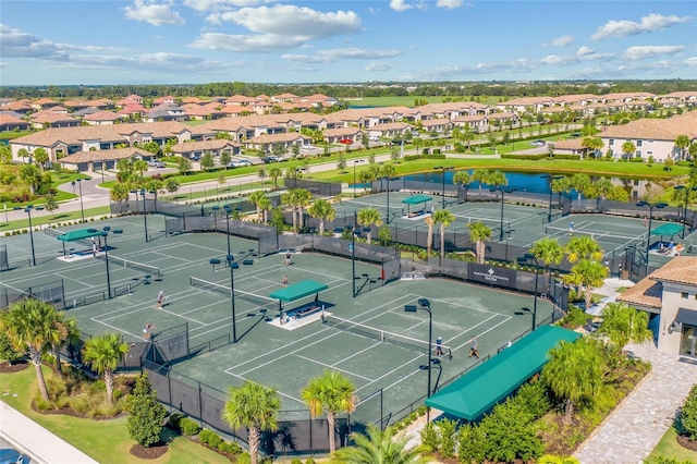 drone / aerial view with a residential view and a water view