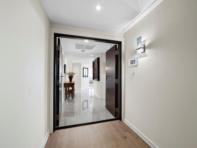 hallway with light wood-style flooring and baseboards