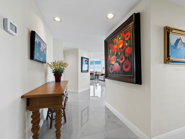 hallway featuring light tile patterned floors, recessed lighting, and baseboards