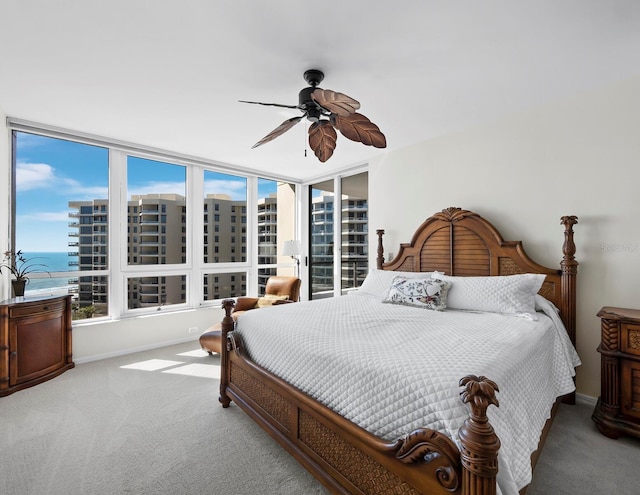 carpeted bedroom with baseboards and a ceiling fan