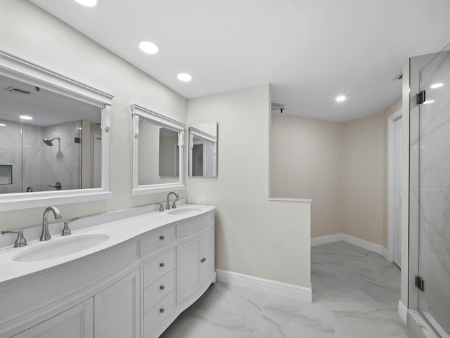 full bath featuring marble finish floor, a shower stall, and a sink