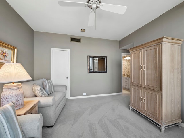 sitting room with light colored carpet, baseboards, visible vents, and a ceiling fan