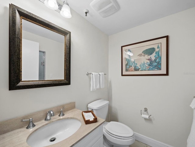 bathroom featuring visible vents, baseboards, toilet, and vanity