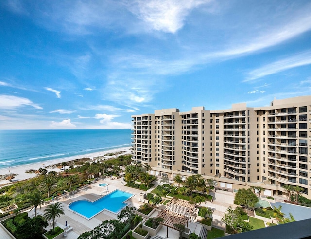 birds eye view of property featuring a beach view and a water view