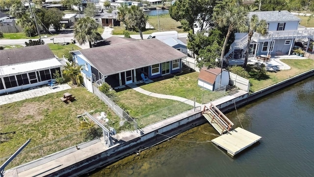 drone / aerial view featuring a residential view and a water view