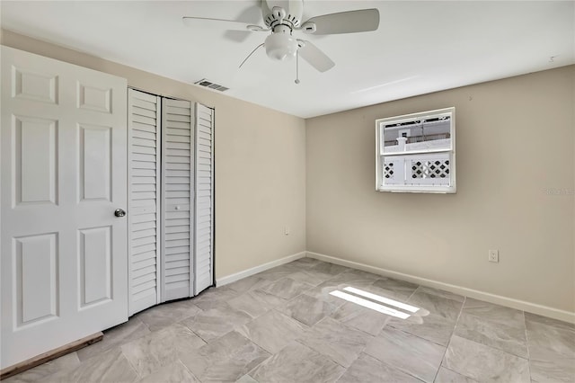 unfurnished bedroom featuring a closet, baseboards, ceiling fan, and visible vents