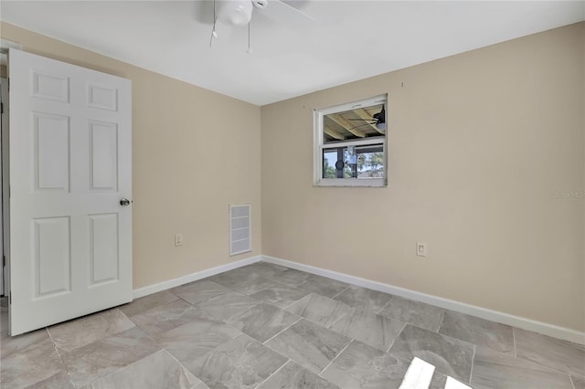 unfurnished room with baseboards, visible vents, and a ceiling fan
