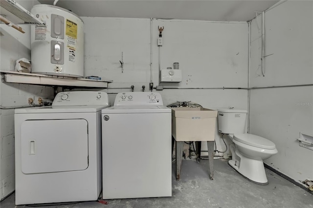 laundry room featuring water heater, washing machine and dryer, a sink, and laundry area