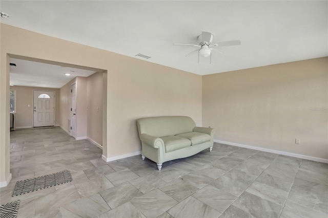 unfurnished room with baseboards, ceiling fan, and visible vents