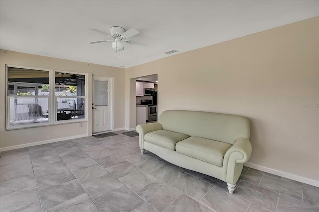 sitting room with a ceiling fan, baseboards, and visible vents