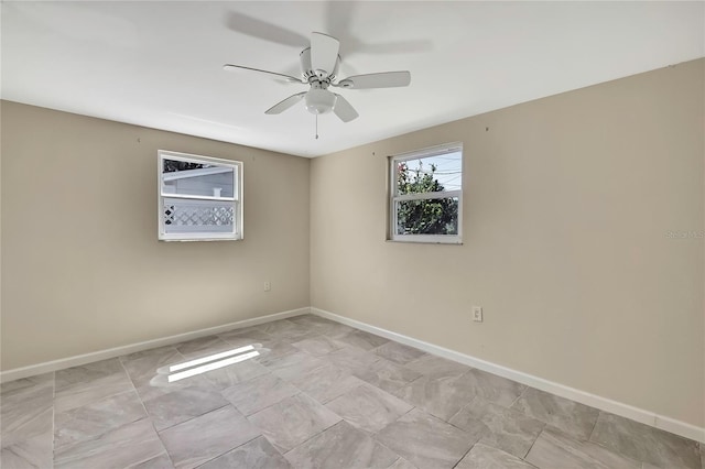 spare room featuring baseboards and ceiling fan
