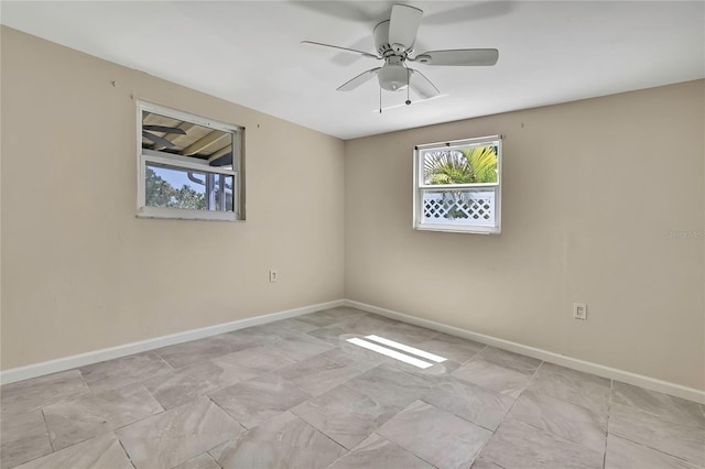unfurnished room with baseboards and ceiling fan