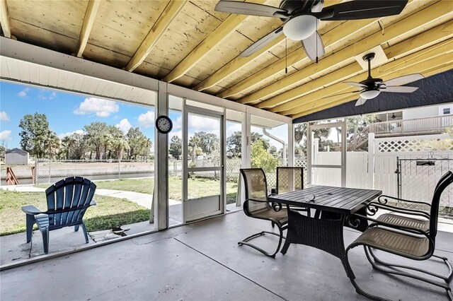 sunroom featuring outdoor dining space and ceiling fan