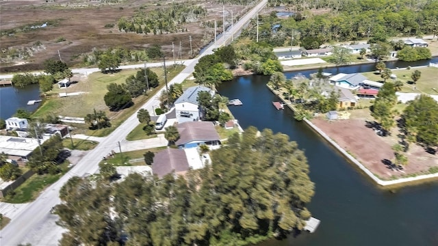 birds eye view of property with a water view and a residential view