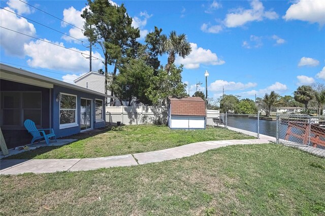 14914 Old Dixie Hwy, Hudson, FL 34667 - view of yard with fence, a water view, a shed, and an outbuilding