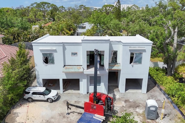 view of front of house featuring stucco siding and a balcony