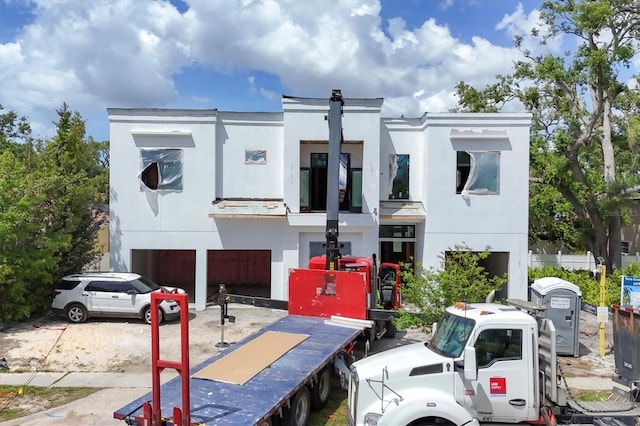 view of front facade with a garage and stucco siding
