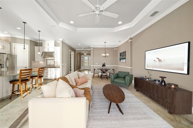 living room featuring arched walkways, visible vents, recessed lighting, and a raised ceiling