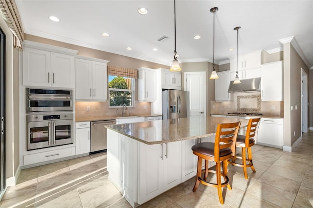 kitchen with under cabinet range hood, a sink, a center island, white cabinetry, and appliances with stainless steel finishes