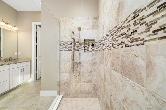 bathroom featuring vanity, tile patterned floors, and a walk in shower