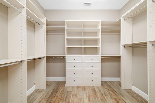 spacious closet featuring light wood finished floors and visible vents