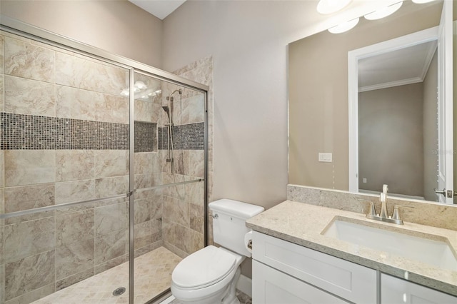 full bath with vanity, crown molding, toilet, and a stall shower