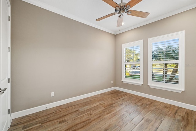 spare room featuring ceiling fan, light wood-style flooring, baseboards, and ornamental molding