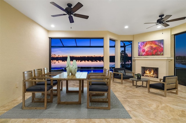 dining space featuring a ceiling fan, recessed lighting, a fireplace, and a textured wall